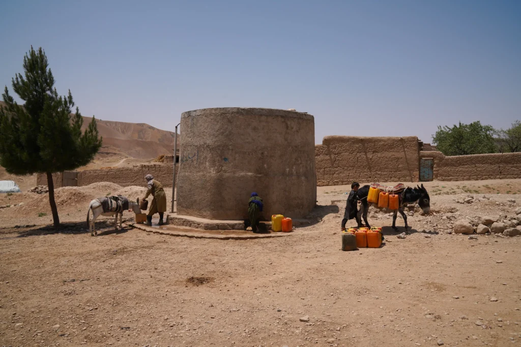 Residents of Dar-e-Suf Payin, Samangan, Afghanistan, collecting water from a small reservoir amid worsening drought. [IC: FAO/Hashim Azizi].