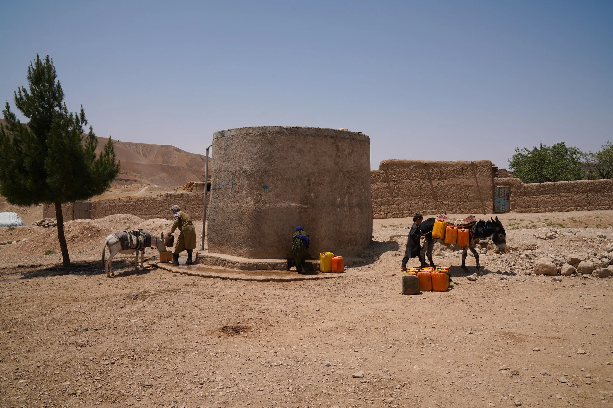 Residents of Dar-e-Suf Payin, Samangan, Afghanistan, collecting water from a small reservoir amid worsening drought. [IC: FAO/Hashim Azizi].
