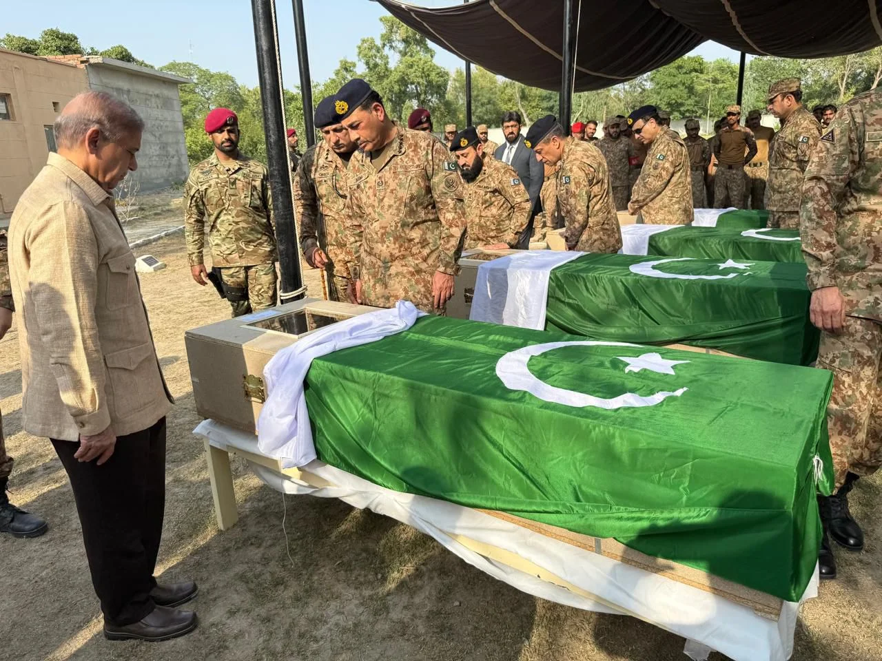 Prime Minister Shehbaz Sharif, Chief of Army Staff Field Marshal Syed Asim Munir and senior officials gathered for the funeral prayers of 12 martyred soldiers in South Waziristan; Defence Minister questions absence of KP CM. [Courtesy: Khawaja Asif/X].
