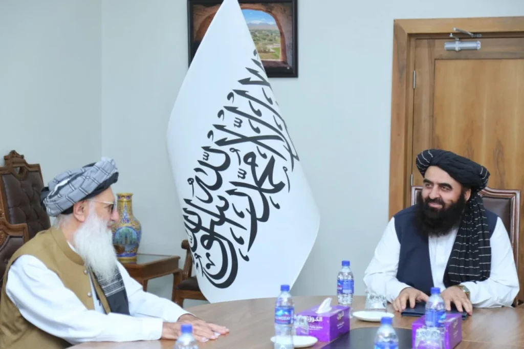 Afghan Foreign Minister Amir Khan Muttaqi in close discussion with Jamaat-e-Islami leader Professor Muhammad Ibrahim. [Courtesy: HTN Monitoring Team].