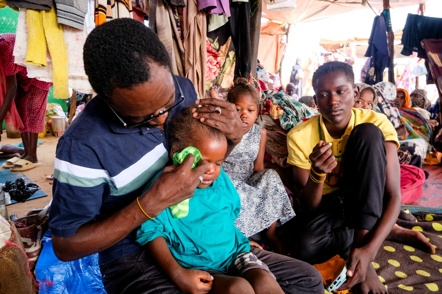 A displaced Sudanese man reunites with his family after fleeing Al Fasher city, September 6, 2025. / Reuters