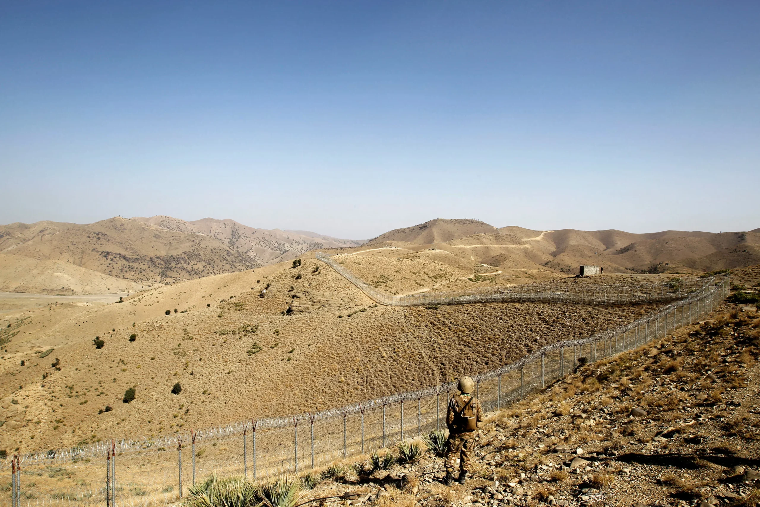 A Pakistani soldier stands guard near the border fence at the Kitton outpost in North Waziristan, overlooking Afghanistan, October 18, 2017. [Courtesy: Reuters].