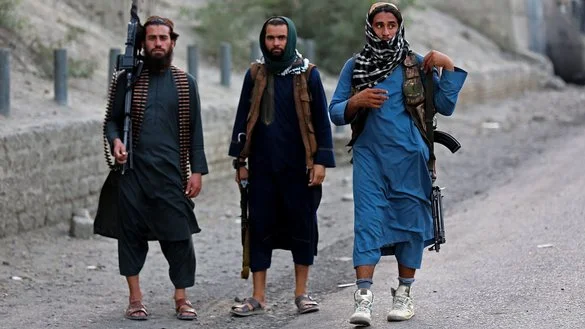 Security personnel pose for a photograph near the closed gates of the Torkham border crossing between Afghanistan and Pakistan in Nangarhar province, Afghanistan, on September 6, 2023. [Shafiullah Kakar/AFP]