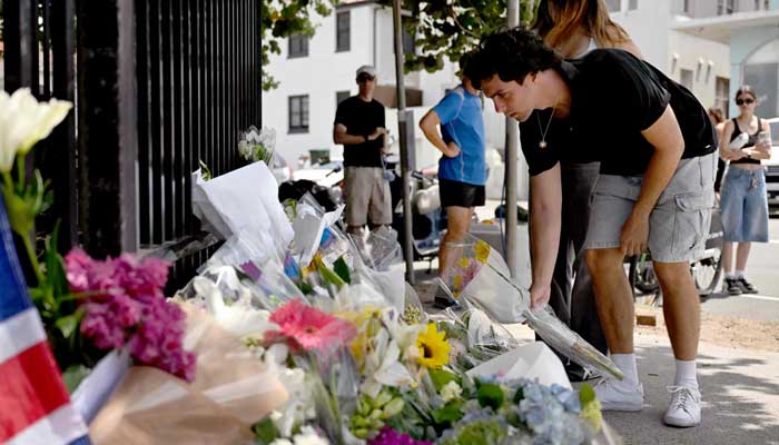 Mourners gather at Sydney’s Bondi Pavilion on Monday, December 15, 2025, to lay floral tributes for the victims of the Bondi Beach shooting