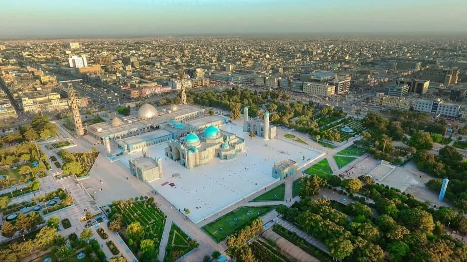 Aerial view of Mazar-e-Sharif, showing urban districts and surrounding landscape under soft daylight. The photograph provides geographic context to the news report on the killing of a Turkmen elder. [Courtesy: Hasht-e-Subah]